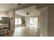 Open concept living room with wood flooring, ceiling fan, natural light, and sliding doors to screened in patio at 1220 Dustin Dr, Lady Lake, FL 32159
