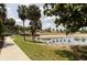 Scenic pond view with clear water, lush greenery, and a walking path for tranquil enjoyment at 1220 Dustin Dr, Lady Lake, FL 32159