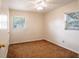 Bedroom featuring natural lighting from 2 windows, overhead light with fan and neutral walls at 1244 Woodland Ave, Lakeland, FL 33801