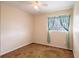 Bedroom with neutral walls, carpet flooring, ceiling fan, and a window at 1244 Woodland Ave, Lakeland, FL 33801