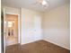 Bedroom with neutral walls, carpet, ceiling fan and attached bathroom at 1244 Woodland Ave, Lakeland, FL 33801