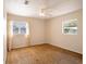 Bedroom featuring two windows, overhead light with fan and neutral-colored walls at 1244 Woodland Ave, Lakeland, FL 33801