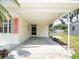 Attached carport providing covered parking and an entryway into the home's side entrance at 1244 Woodland Ave, Lakeland, FL 33801