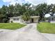 Charming single-story home with a well-maintained lawn and a palm tree in the front yard at 1244 Woodland Ave, Lakeland, FL 33801