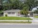 Charming single-story home with a well-maintained lawn and a palm tree in the front yard at 1244 Woodland Ave, Lakeland, FL 33801