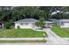 Charming single-story home with a well-maintained lawn and a palm tree in the front yard at 1244 Woodland Ave, Lakeland, FL 33801