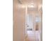Hallway with tile floor, neutral walls, and white doors leading to other rooms at 1244 Woodland Ave, Lakeland, FL 33801