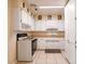 Kitchen with white cabinets, tan countertops, and ceramic tile flooring at 1244 Woodland Ave, Lakeland, FL 33801