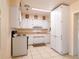 Bright kitchen with white cabinets, tan countertops, and ceramic tile floors at 1244 Woodland Ave, Lakeland, FL 33801