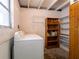 Laundry room features a washing machine, shelving, and natural lighting at 1244 Woodland Ave, Lakeland, FL 33801