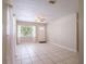 Spacious living room showcasing neutral walls, tiled floors, and a front door view at 1244 Woodland Ave, Lakeland, FL 33801