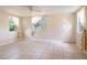 Spacious living room with tile flooring, ceiling fan, and natural light from windows at 1244 Woodland Ave, Lakeland, FL 33801