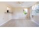Living room with tile flooring, a ceiling fan, and natural light through the windows at 1244 Woodland Ave, Lakeland, FL 33801