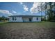 Image of the house rear, showcasing a large backyard with lush surroundings at 13420 Sw 77Th Ave, Ocala, FL 34473