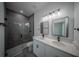 Modern bathroom featuring a glass shower, dual vanities, and sleek fixtures at 13420 Sw 77Th Ave, Ocala, FL 34473