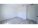 Neutrally painted bedroom featuring wood-look floors and a closet with bi-fold doors at 13420 Sw 77Th Ave, Ocala, FL 34473