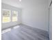 Bright bedroom with gray wood-look flooring and closet at 13420 Sw 77Th Ave, Ocala, FL 34473