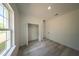 Bright bedroom with gray wood-look flooring and open closet at 13420 Sw 77Th Ave, Ocala, FL 34473