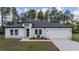 Beautifully landscaped one-story home with a two-car garage and modern architectural details at 13420 Sw 77Th Ave, Ocala, FL 34473