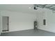Spacious garage interior with modern fixtures, concrete flooring, and clean lines at 13420 Sw 77Th Ave, Ocala, FL 34473