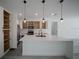 Bright kitchen with white cabinets, stainless steel appliances, a large island, and pendant lighting at 13420 Sw 77Th Ave, Ocala, FL 34473
