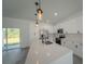Modern kitchen with white cabinetry, stainless steel appliances, and a large center island at 13420 Sw 77Th Ave, Ocala, FL 34473