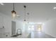Well-lit living room boasts sleek floors and a view of a bright white kitchen at 13420 Sw 77Th Ave, Ocala, FL 34473