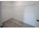 Empty walk-in closet with gray wood-look flooring and wire shelving at 13420 Sw 77Th Ave, Ocala, FL 34473