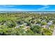 The home in a lush neighborhood with mature trees and a tranquil lake in the distance, marked with locator pin at 1408 Watts Ave, Orlando, FL 32809