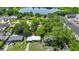 A bird's eye view of a home nestled within a lush neighborhood, highlighted with a locator pin at 1408 Watts Ave, Orlando, FL 32809