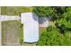Aerial view of a single-story home featuring mature trees and a long driveway at 1408 Watts Ave, Orlando, FL 32809