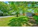 Lush backyard offering plenty of space for gardening, recreation, with mature trees for ample shade at 1408 Watts Ave, Orlando, FL 32809