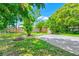 Expansive backyard featuring mature trees, a paved area, fire pit, and a well-maintained wooden fence at 1408 Watts Ave, Orlando, FL 32809