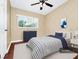Cozy bedroom featuring neutral color palette, modern decor, and laminate floors at 1408 Watts Ave, Orlando, FL 32809
