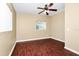 Empty bedroom featuring hardwood floors, neutral paint, a ceiling fan, and a window for natural light at 1408 Watts Ave, Orlando, FL 32809