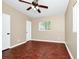 Empty bedroom featuring hardwood floors, neutral paint, a ceiling fan, and a window for natural light at 1408 Watts Ave, Orlando, FL 32809