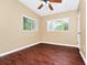 Bedroom featuring wood-look flooring, neutral walls, a ceiling fan, and a window with natural light at 1408 Watts Ave, Orlando, FL 32809