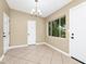 Open dining area with neutral paint, tile floors, a chandelier, and a large window for natural light at 1408 Watts Ave, Orlando, FL 32809