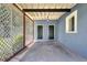Covered entrance featuring dual doors and decorative lattice at 1408 Watts Ave, Orlando, FL 32809