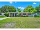 Well-kept single-story home featuring a lush green lawn and brick detailing at 1408 Watts Ave, Orlando, FL 32809