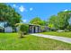 One-story home with a verdant lawn, brick elements, and attached carport at 1408 Watts Ave, Orlando, FL 32809
