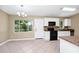 Bright kitchen features white cabinetry, black appliances, tile backsplash and countertops, and natural light at 1408 Watts Ave, Orlando, FL 32809