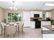 Cozy eat-in kitchen featuring bright white cabinetry and modern appliances at 1408 Watts Ave, Orlando, FL 32809