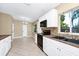 Bright kitchen featuring white cabinets, black appliances, stone tile backsplash, and ample natural light at 1408 Watts Ave, Orlando, FL 32809