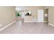 Open living room with neutral walls, ceramic tile flooring, and natural light at 1408 Watts Ave, Orlando, FL 32809