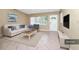 Bright living room featuring a comfortable sofa, stylish decor, and large window views at 1408 Watts Ave, Orlando, FL 32809