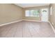 Airy living room with ceramic tile, neutral color scheme, and ample sunlight at 1408 Watts Ave, Orlando, FL 32809