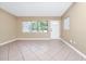 Inviting living room with ceramic tile floors, neutral walls, and bright lighting at 1408 Watts Ave, Orlando, FL 32809