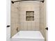 Updated shower with decorative tiled inlay and bronze fixtures at 1408 Watts Ave, Orlando, FL 32809