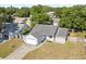 Aerial view of a single-story home with a well-manicured front lawn and mature trees at 1415 Hensley Dr, Deland, FL 32724